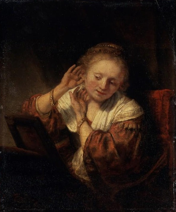 Jovem mulher experimentando brincos – Rembrandt van Rijn Rembrandt van Rijn Artemis Reproduction